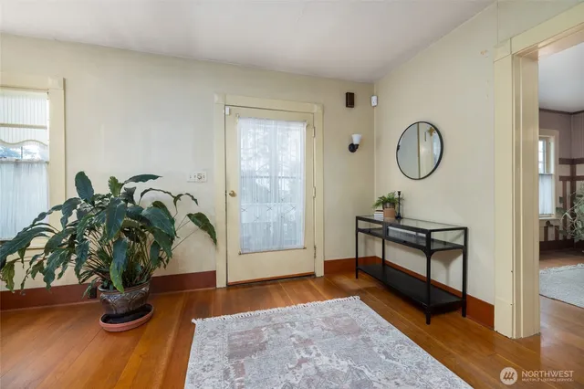 a living room with furniture potted plant and a rug