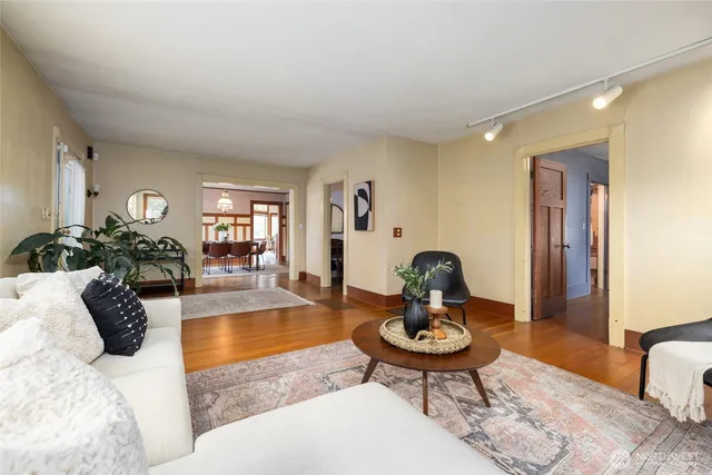 a living room with furniture a rug and a table