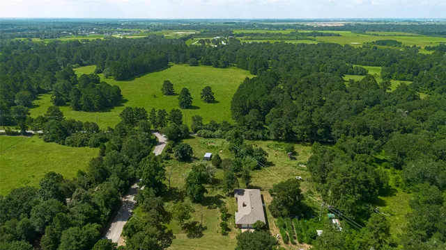 an aerial view of a house with a yard