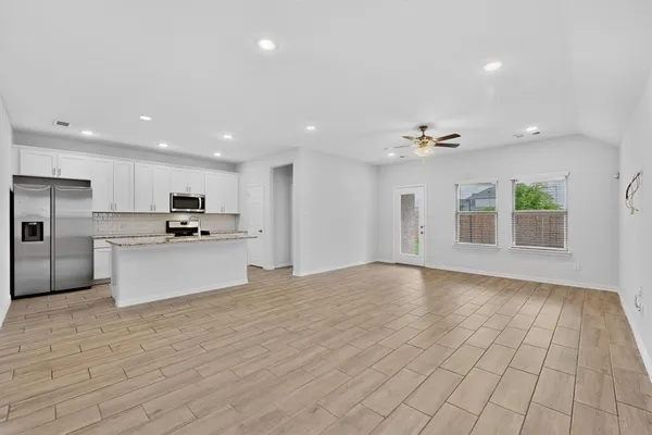 a large kitchen with stainless steel appliances kitchen island a refrigerator sink and cabinets