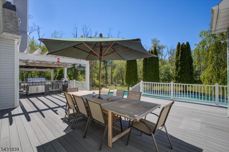 15 Spring Hunter Court Andover, NJ 07821 - Photo 39 of 49 a view of a table and chairs under an umbrella