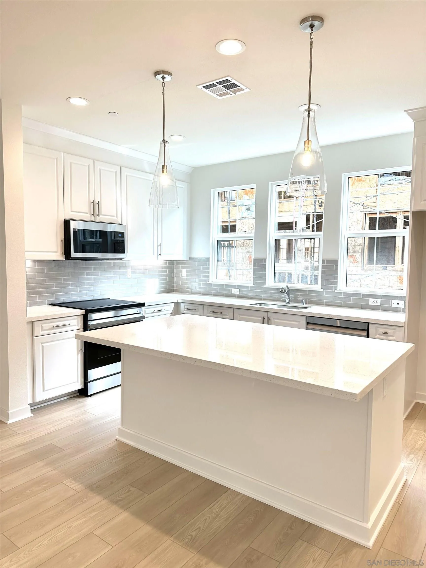 2511 Chamomile Lane Carlsbad, CA 92008 - Photo 1 of 51 a kitchen with stainless steel appliances granite countertop a stove and white cabinets