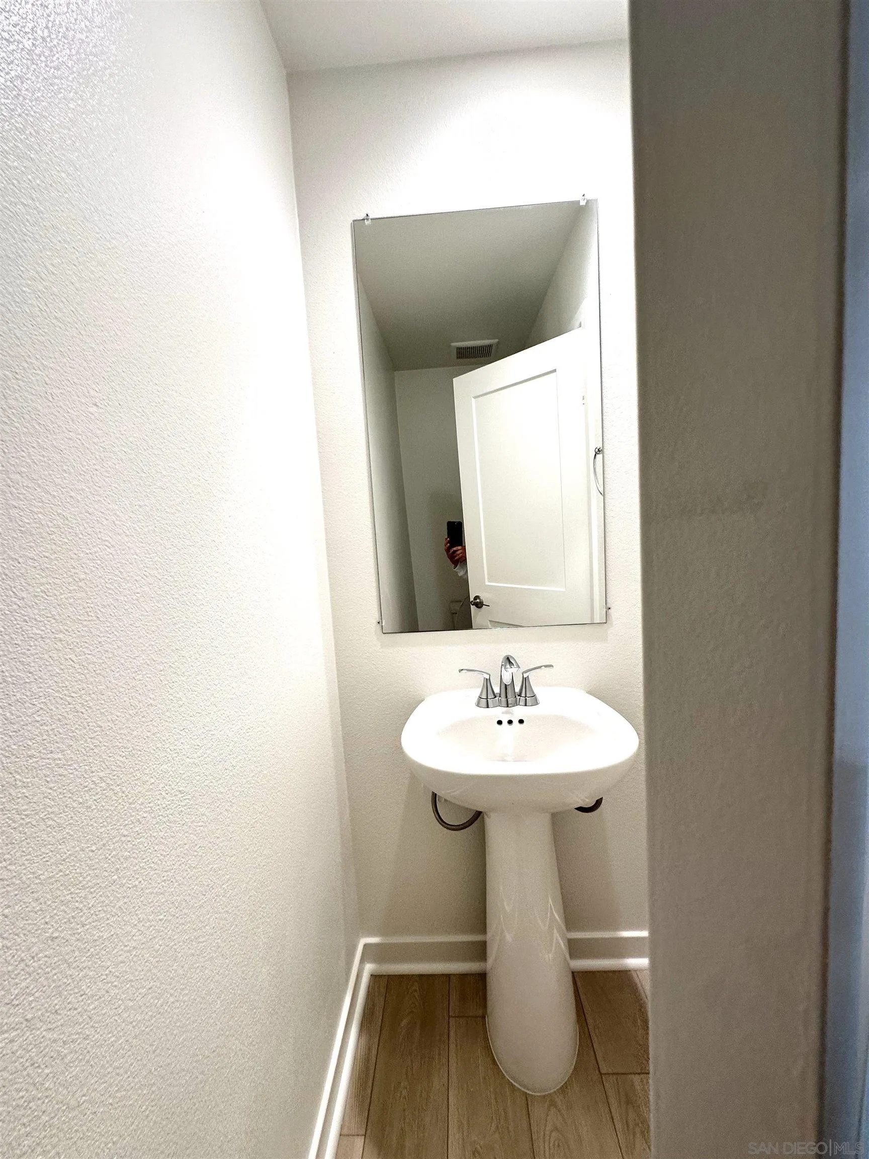 2511 Chamomile Lane Carlsbad, CA 92008 - Photo 21 of 51 a bathroom with a toilet sink and mirror