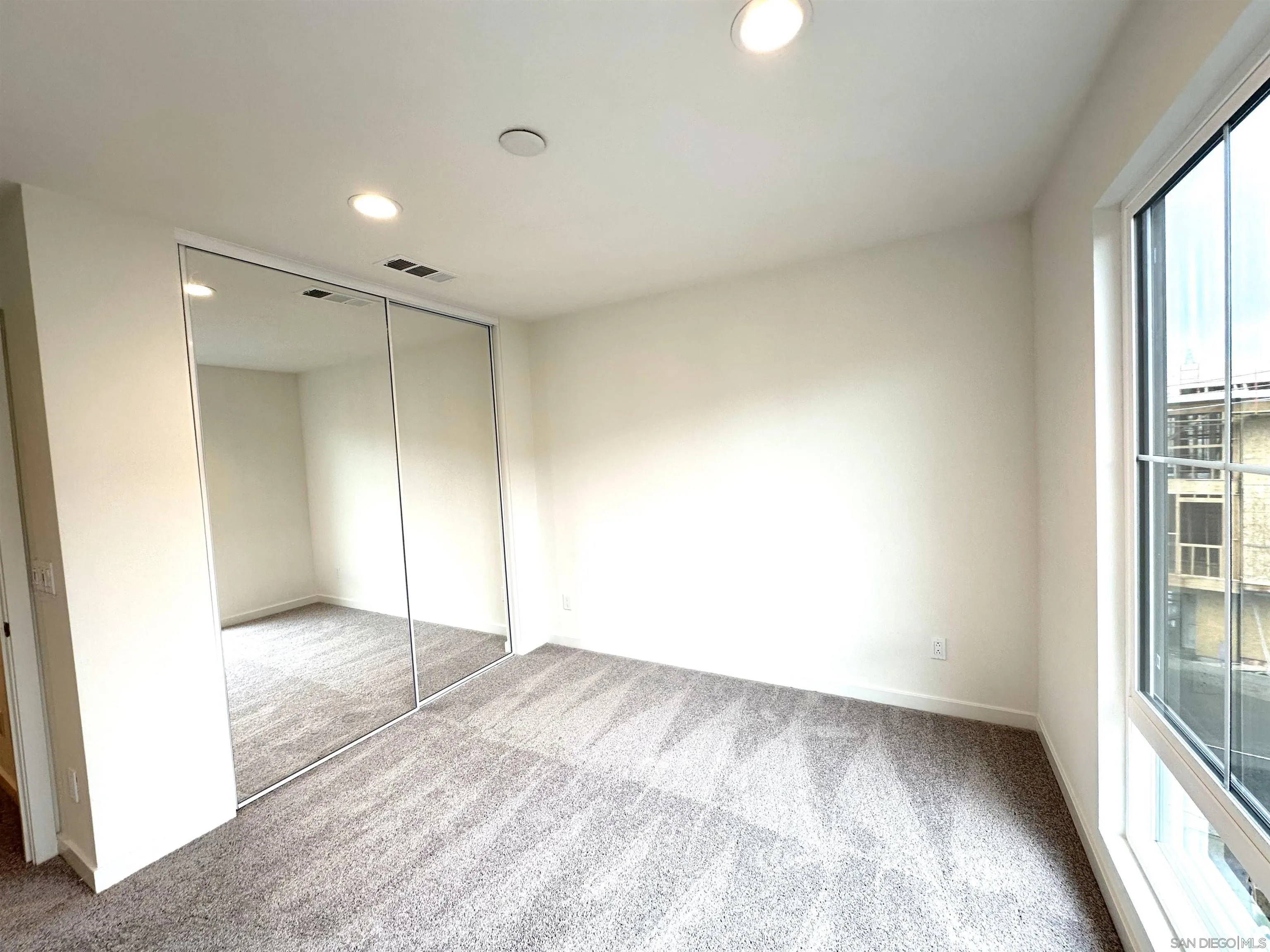 2511 Chamomile Lane Carlsbad, CA 92008 - Photo 24 of 51 an empty room with windows and entrance