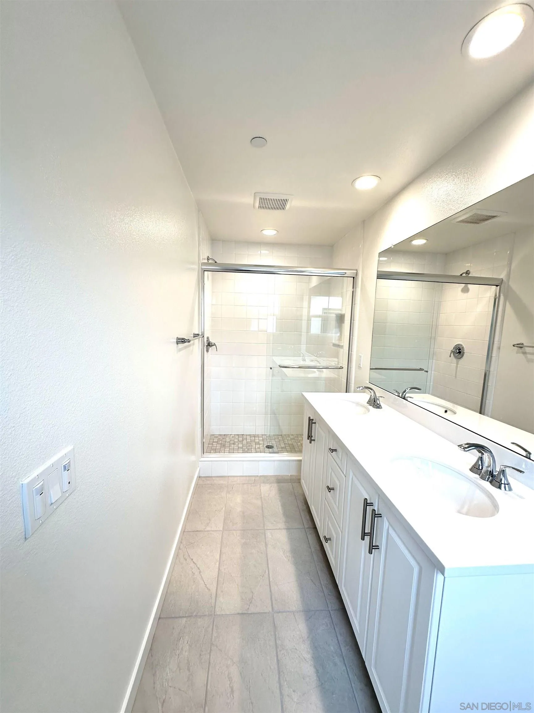 2511 Chamomile Lane Carlsbad, CA 92008 - Photo 33 of 51 a large bathroom with a granite countertop sink a large mirror and a shower