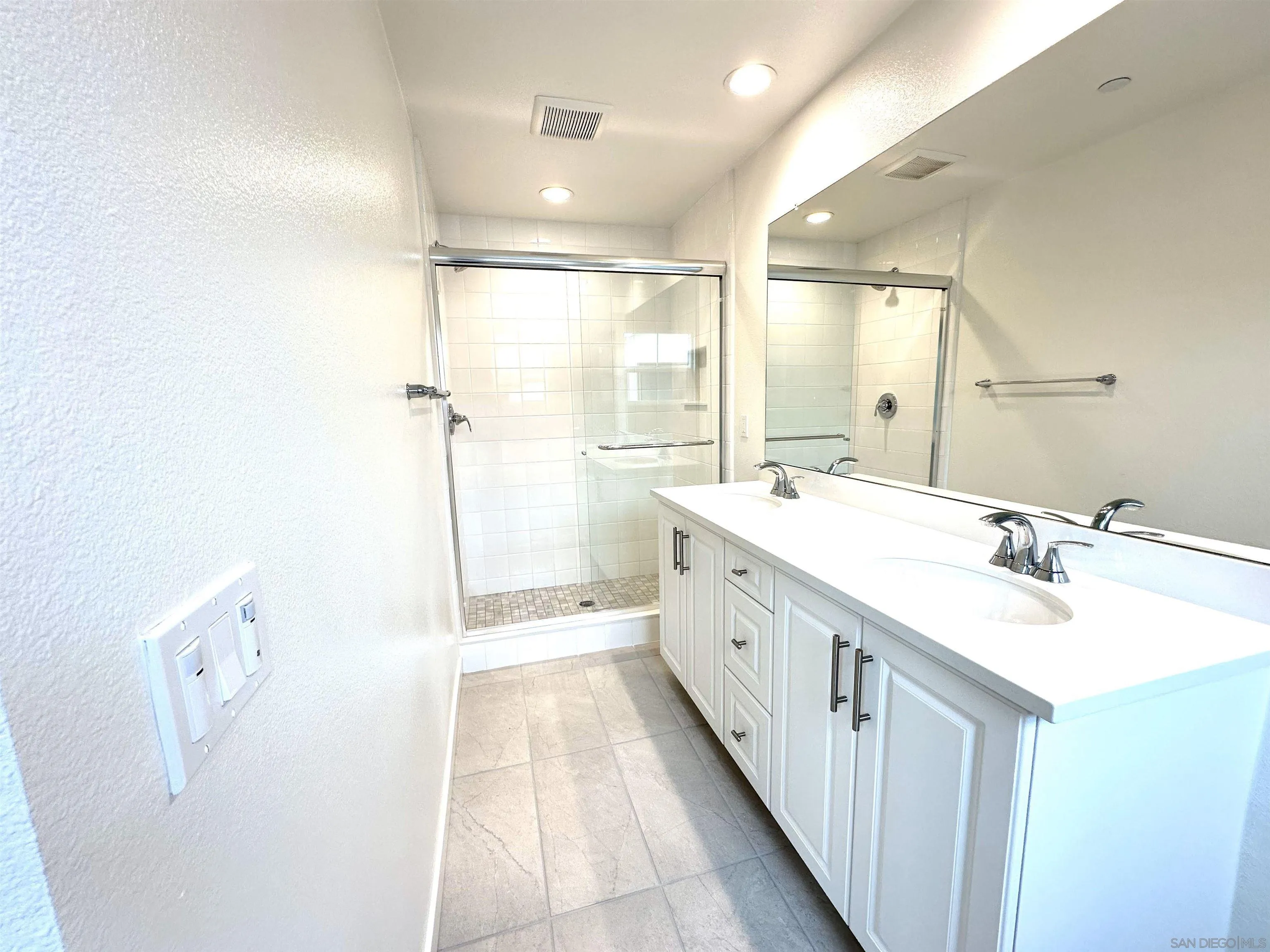 2511 Chamomile Lane Carlsbad, CA 92008 - Photo 34 of 51 a bathroom with a double vanity sink mirror and shower