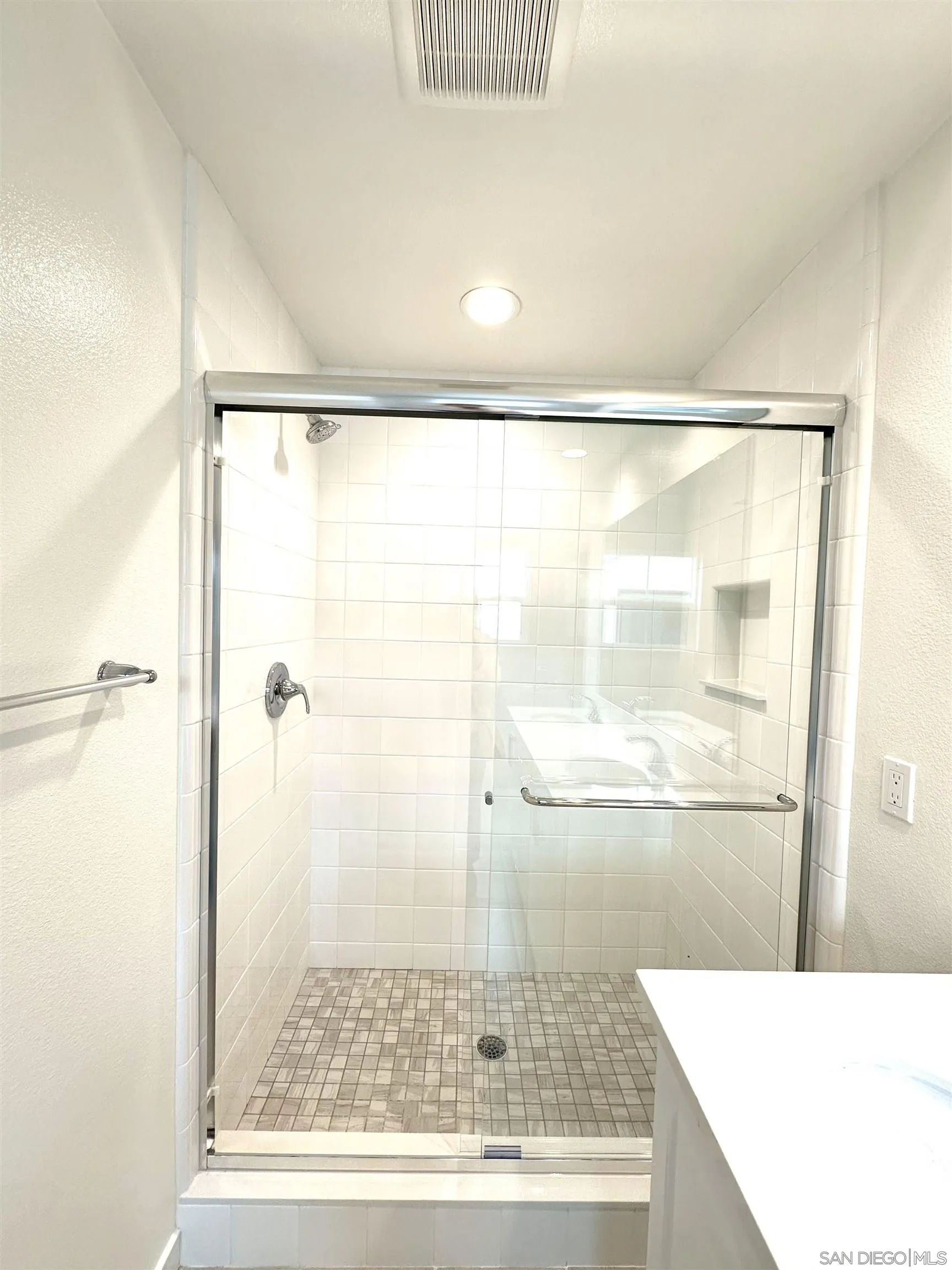 2511 Chamomile Lane Carlsbad, CA 92008 - Photo 35 of 51 a bathroom with a glass shower door