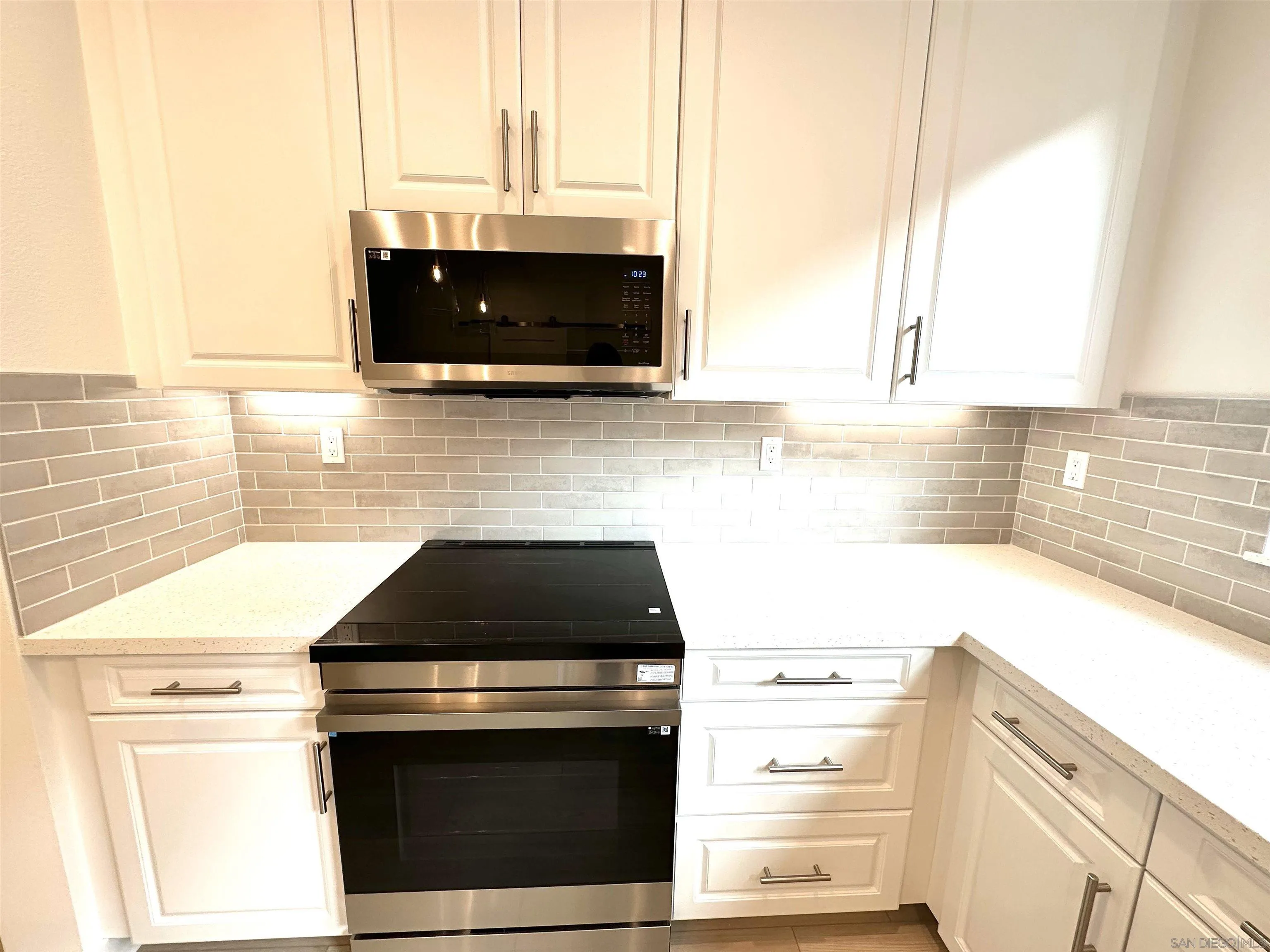 2511 Chamomile Lane Carlsbad, CA 92008 - Photo 6 of 51 a kitchen with stainless steel appliances a stove microwave and sink