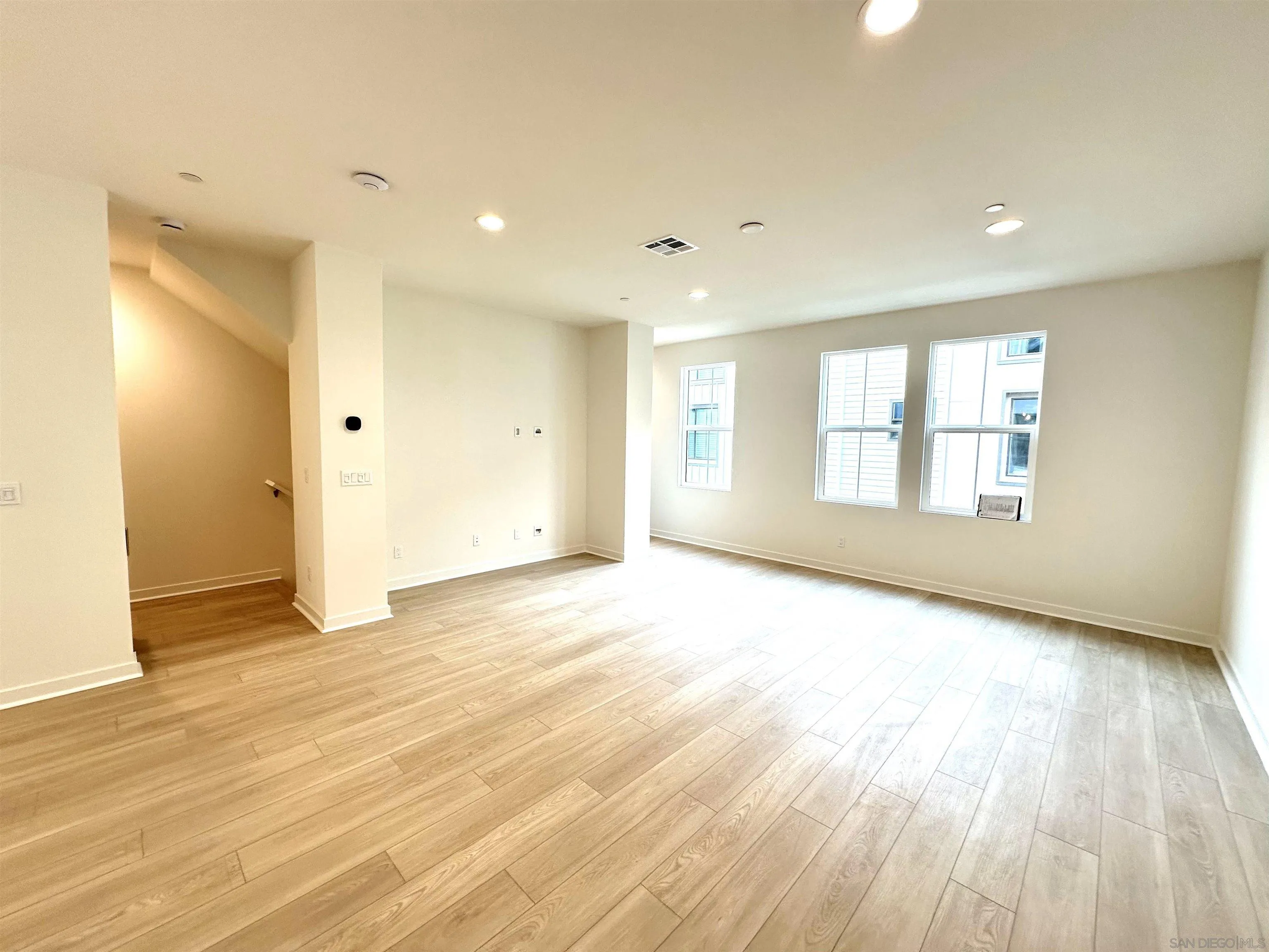 2511 Chamomile Lane Carlsbad, CA 92008 - Photo 10 of 51 a view of an empty room with wooden floor and a window