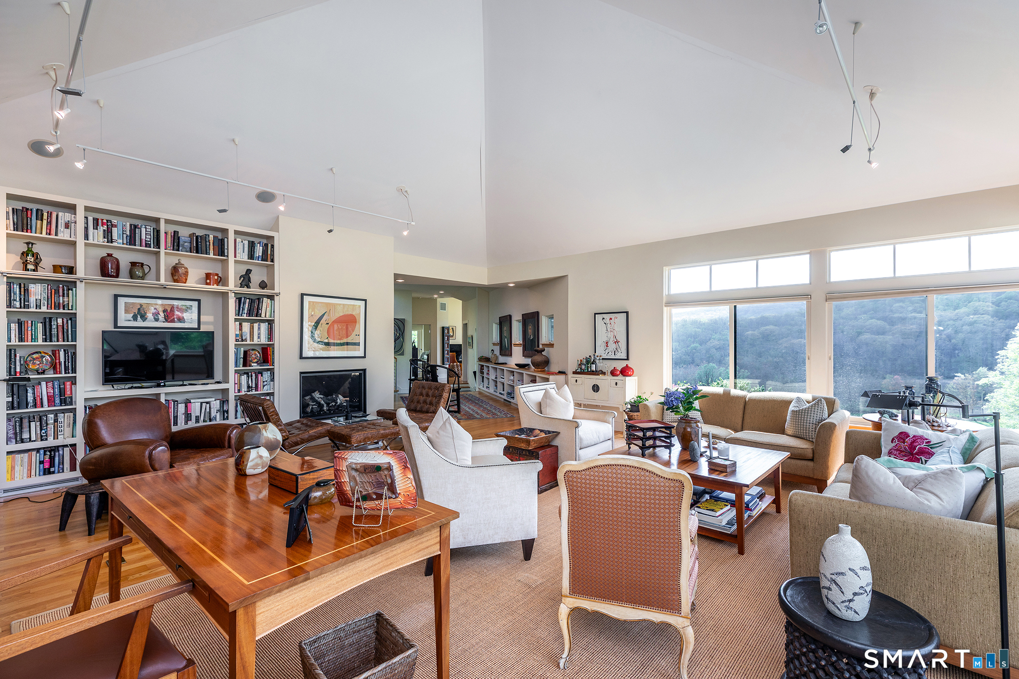 16 Anderson Acres Road Kent, CT 06785 - Photo 12 of 40 a living room with furniture a flat screen tv and a floor to ceiling window