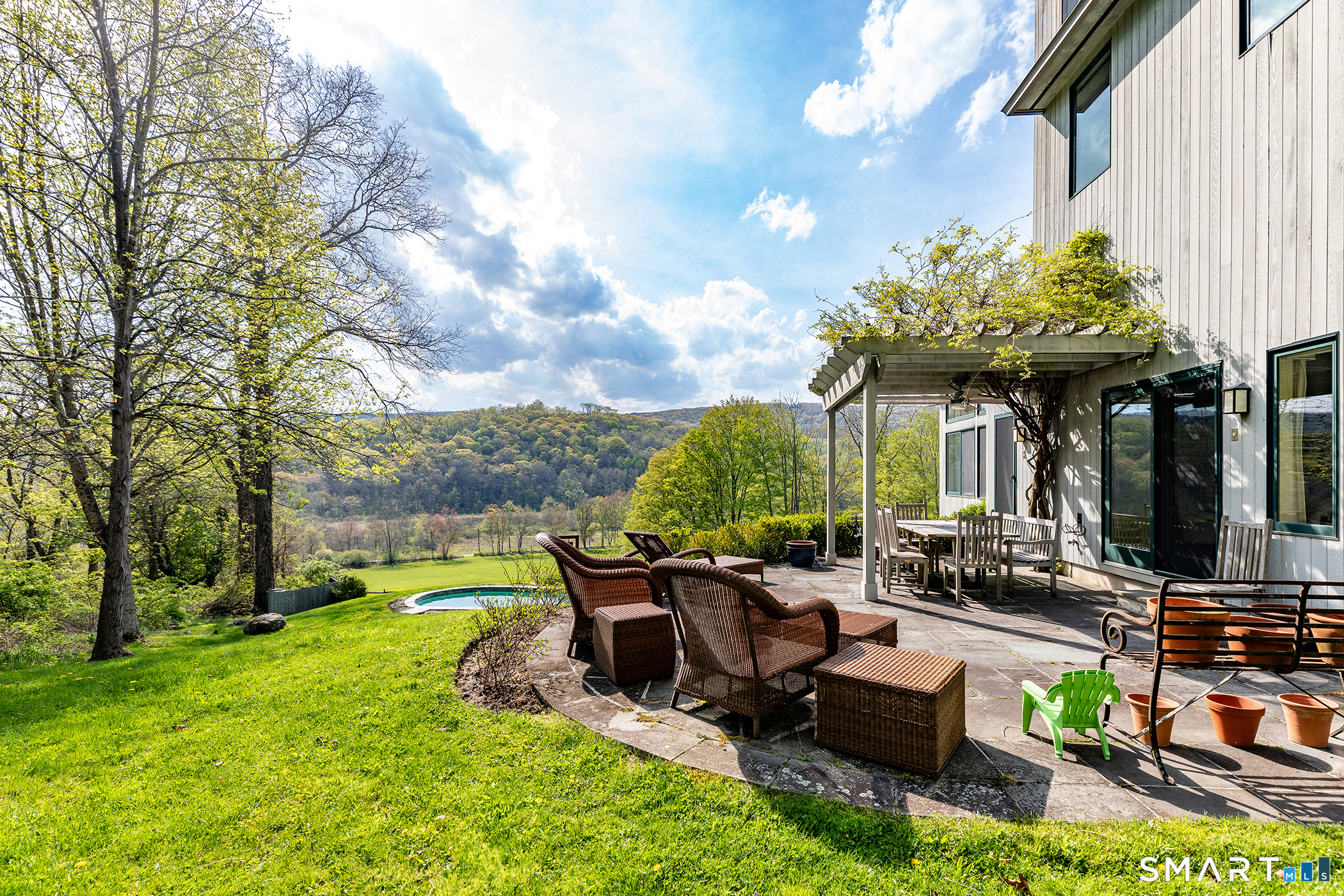 16 Anderson Acres Road Kent, CT 06785 - Photo 3 of 40 a view of a patio with table and chairs potted plants and a large tree