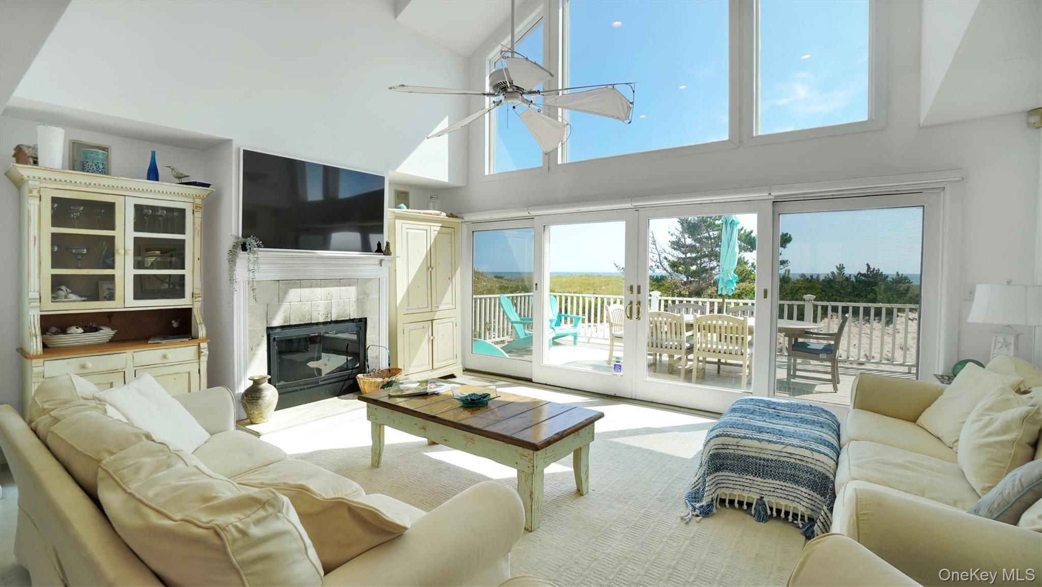 431 Dune Road Westhampton Beach, NY 11978 - Photo 11 of 27 a living room with furniture fireplace and a flat screen tv