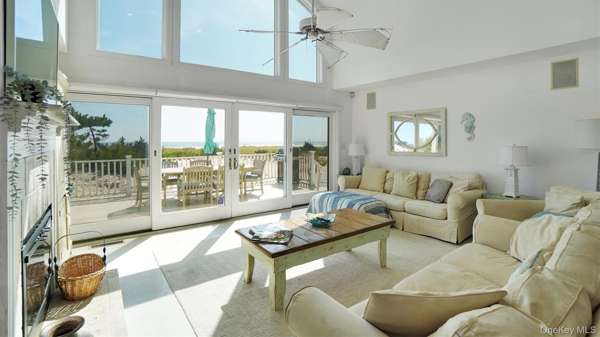 431 Dune Road Westhampton Beach, NY 11978 - Photo 12 of 27 a living room with furniture and a large window
