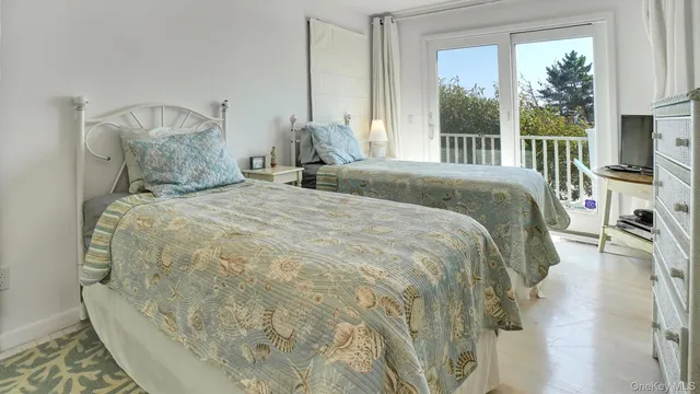 a large bed sitting in a bedroom next to a window