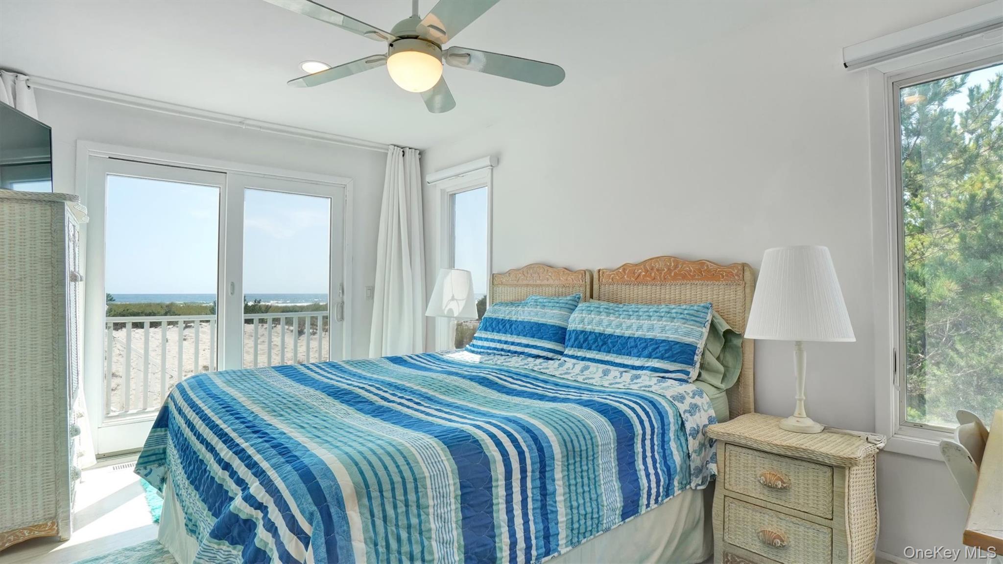 431 Dune Road Westhampton Beach, NY 11978 - Photo 17 of 27 a bedroom with a bed and a chandelier