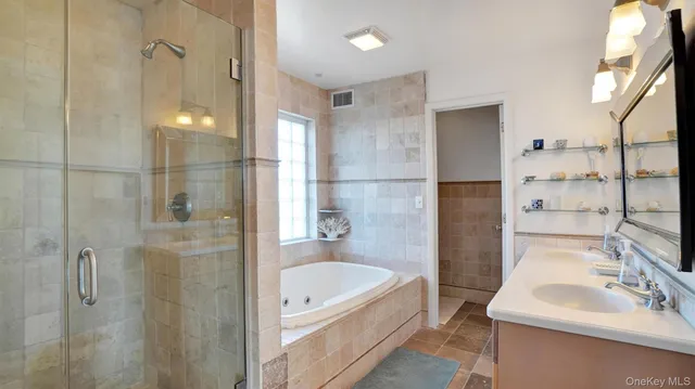 a bathroom with a tub sink and mirror