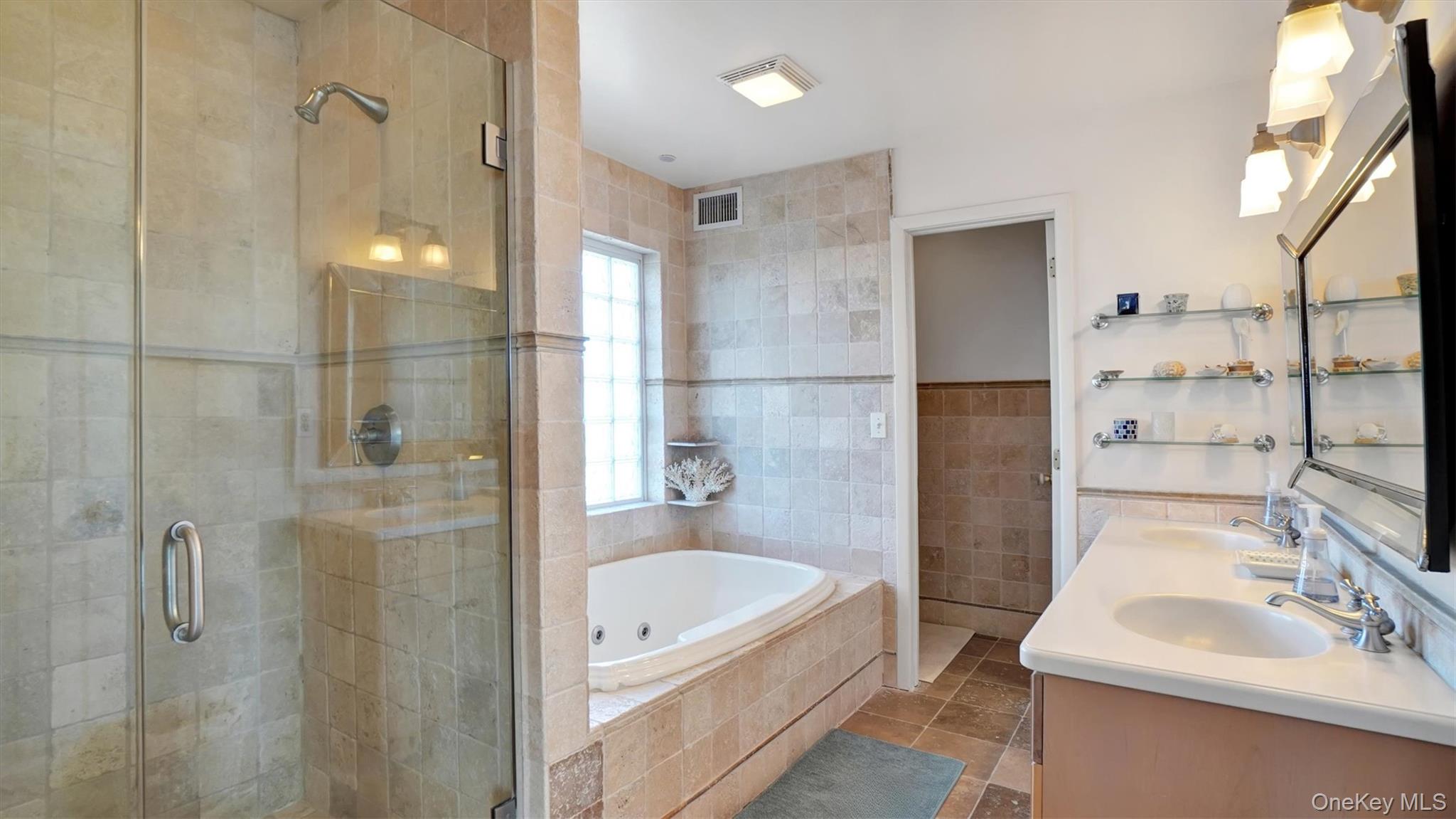 431 Dune Road Westhampton Beach, NY 11978 - Photo 20 of 27 a bathroom with a tub sink and mirror