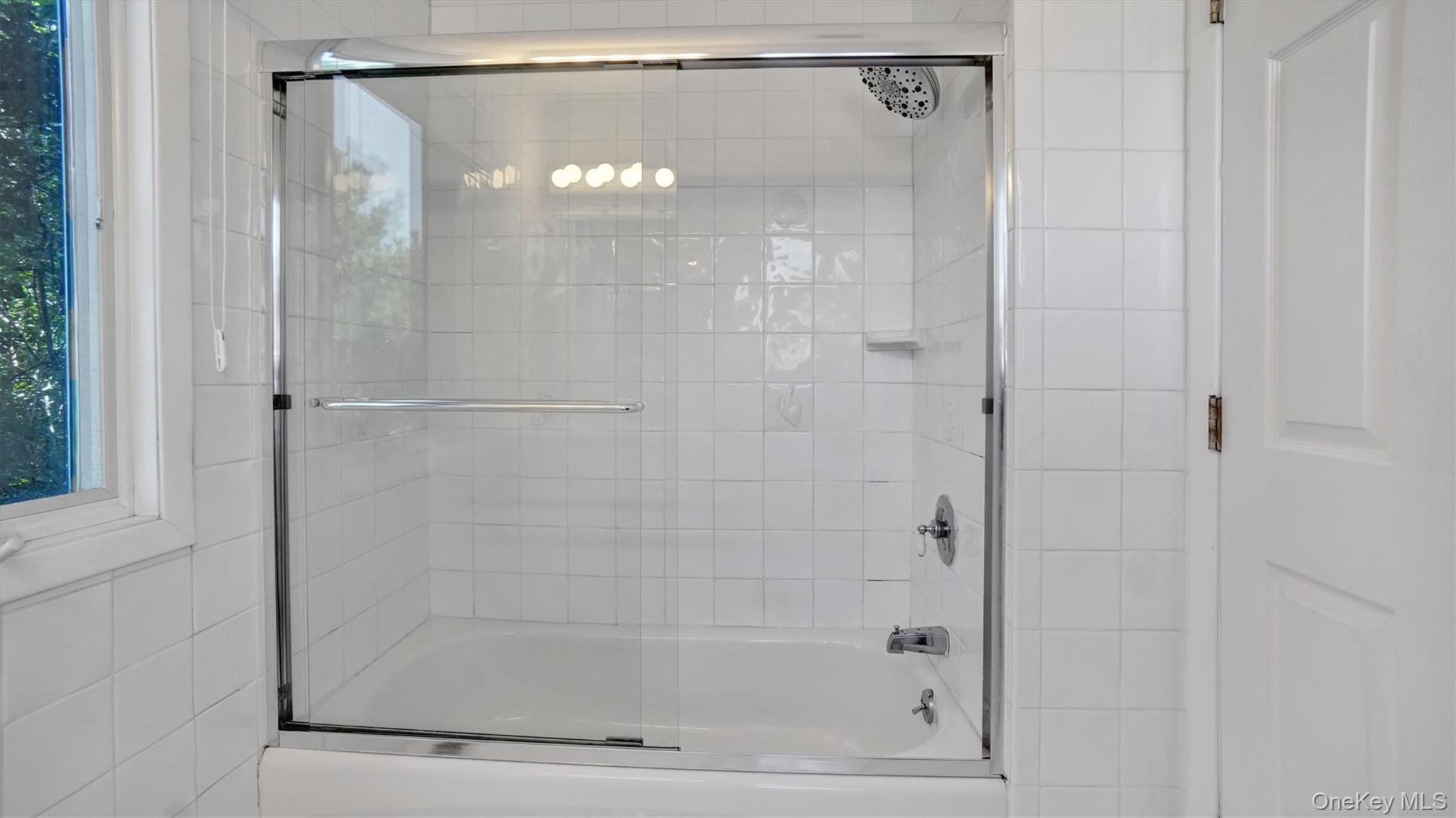 431 Dune Road Westhampton Beach, NY 11978 - Photo 23 of 27 a bathroom with a glass shower door