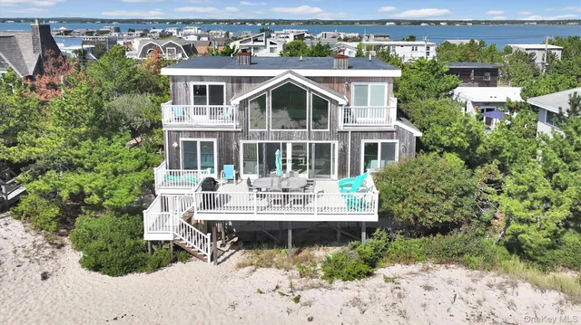 a view of a house with backyard sitting area and garden