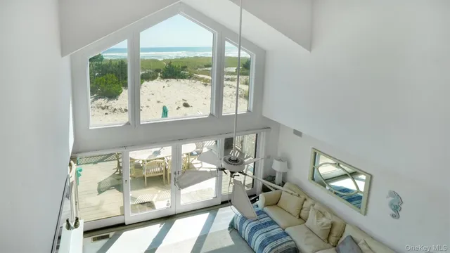 a large kitchen with kitchen island a large window a sink and a refrigerator