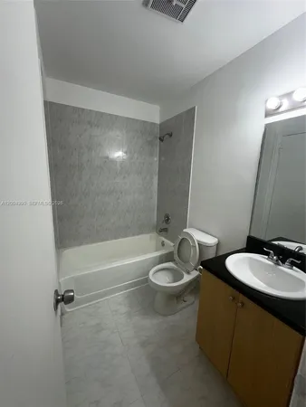 a bathroom with a sink a toilet and bathtub