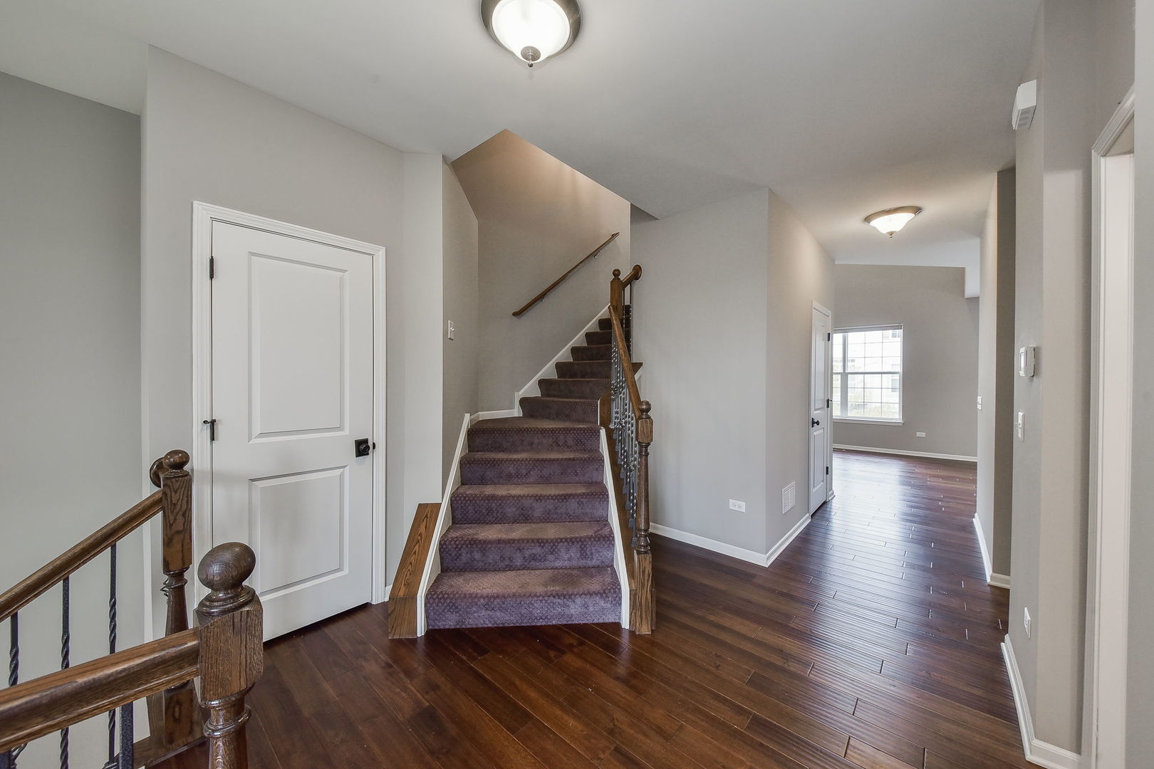 243 Bennett Drive Carol Stream, IL 60188 - Photo 14 of 23 a view of a hallway with wooden floor and stairs