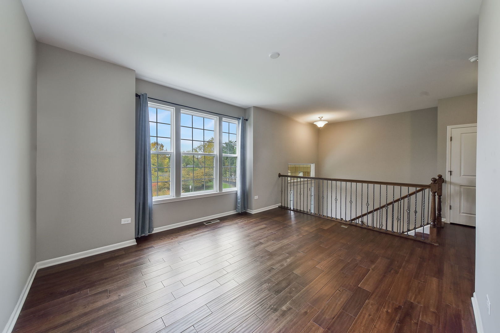 243 Bennett Drive Carol Stream, IL 60188 - Photo 2 of 23 a view of a room with wooden floor and windows