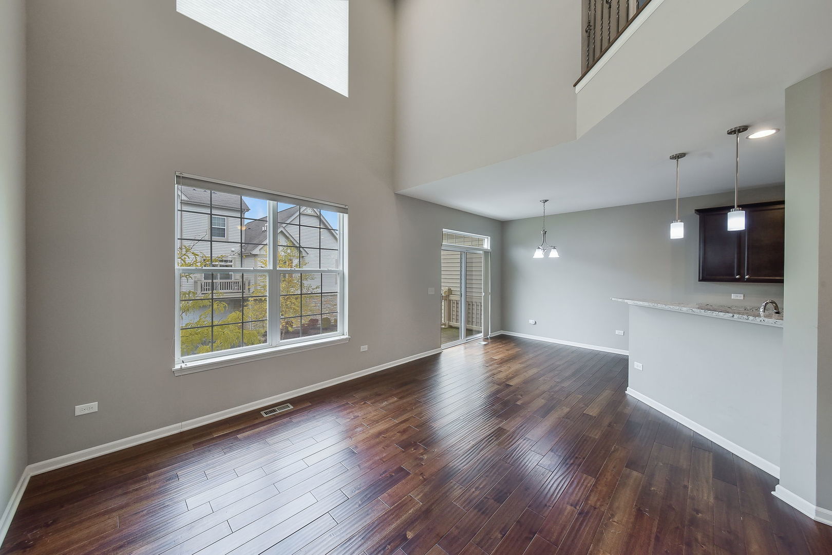 243 Bennett Drive Carol Stream, IL 60188 - Photo 5 of 23 a view of an empty room with a window and wooden floor