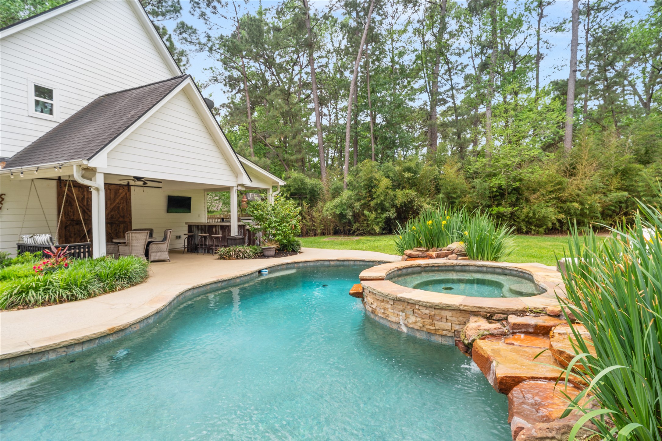 36 Wind River Drive Conroe, TX 77384 - Photo 12 of 45 Looking across the pool towards the outdoor kitchen.