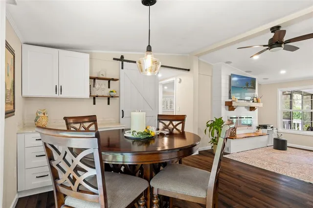 a hallway with a dining table and chairs