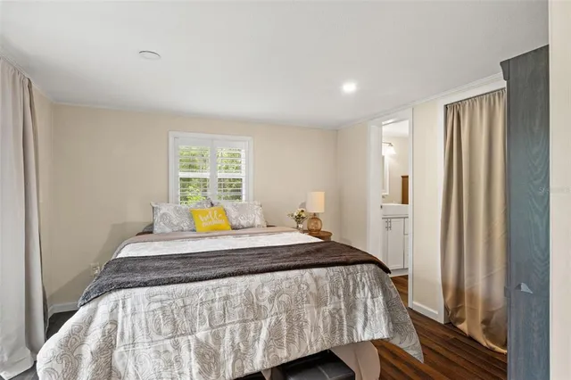 a bed sitting in a bedroom next to a window