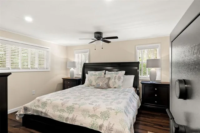 a bedroom with a bed and a mirror on the dresser