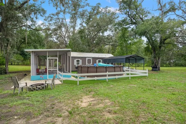 a view of house with a yard from a balcony