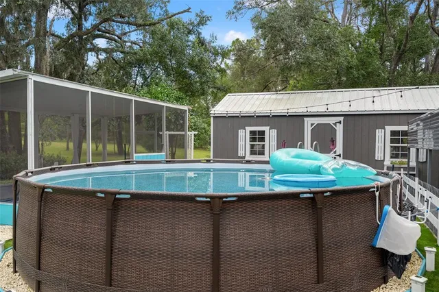 a backyard of a house with table and chairs