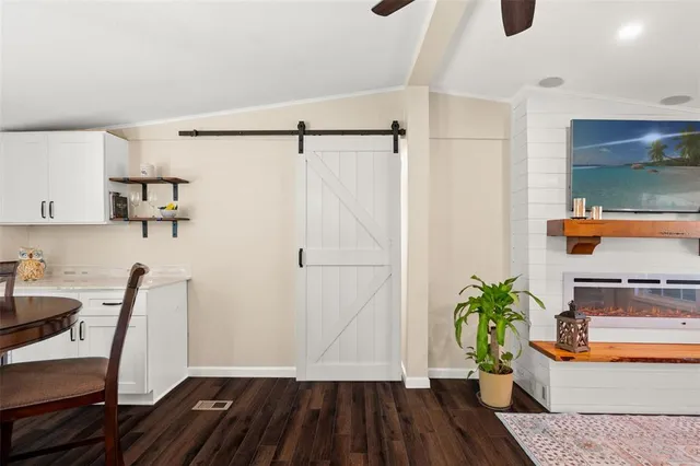 a living room with furniture fireplace and flat screen tv