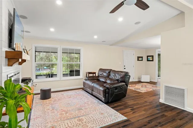 a living room with furniture and a wooden floor
