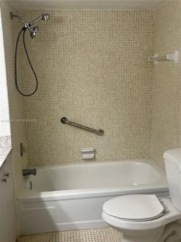 a bathroom with a toilet and a bath tub