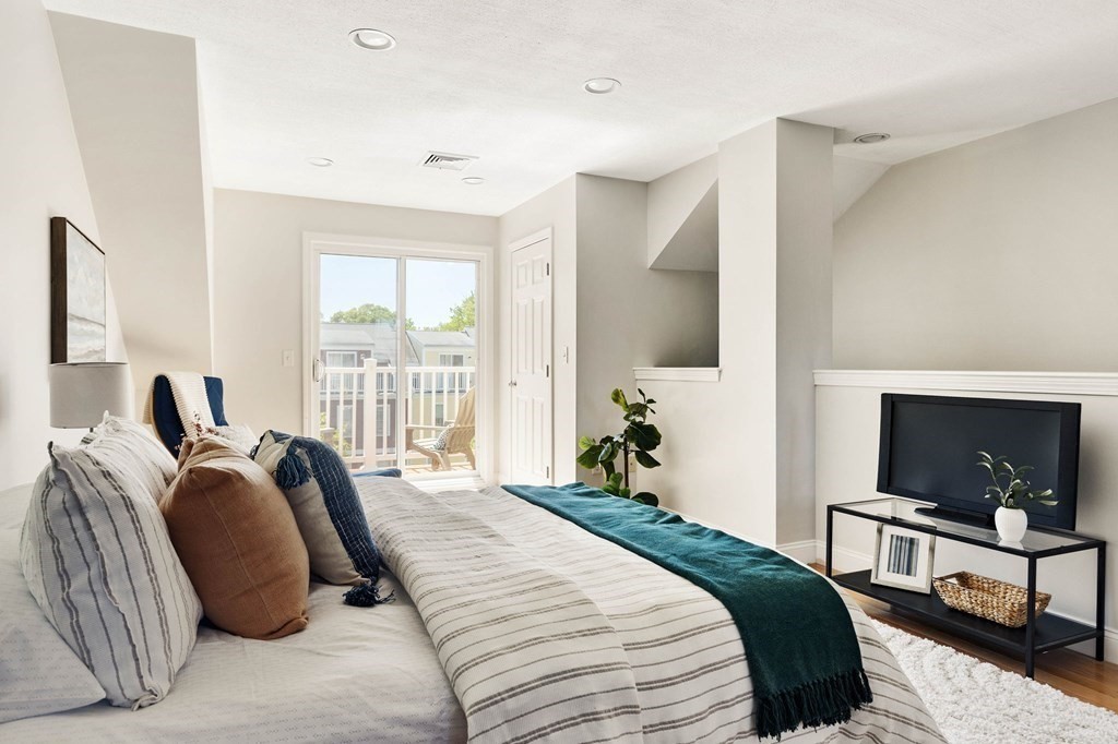 40 Brattle Street, Unit 7 Arlington, MA 02476 - Photo 11 of 25 a bedroom with a bed and a flat screen tv