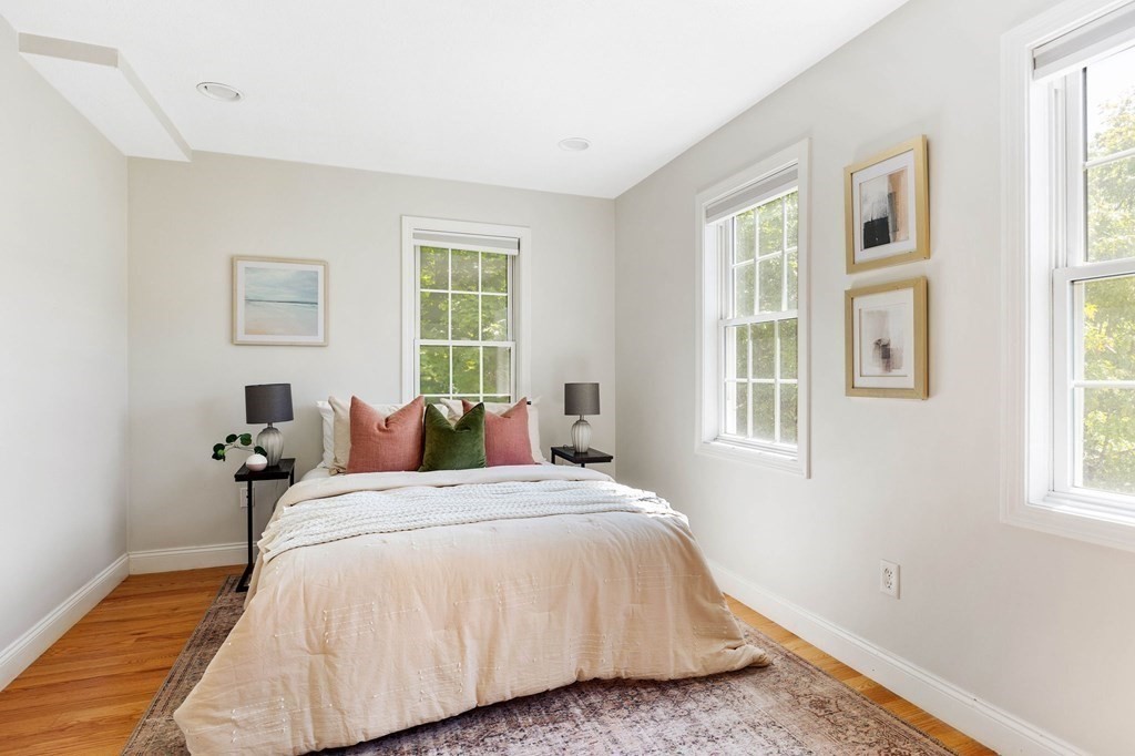 40 Brattle Street, Unit 7 Arlington, MA 02476 - Photo 16 of 25 a bed sitting in a bedroom next to a window