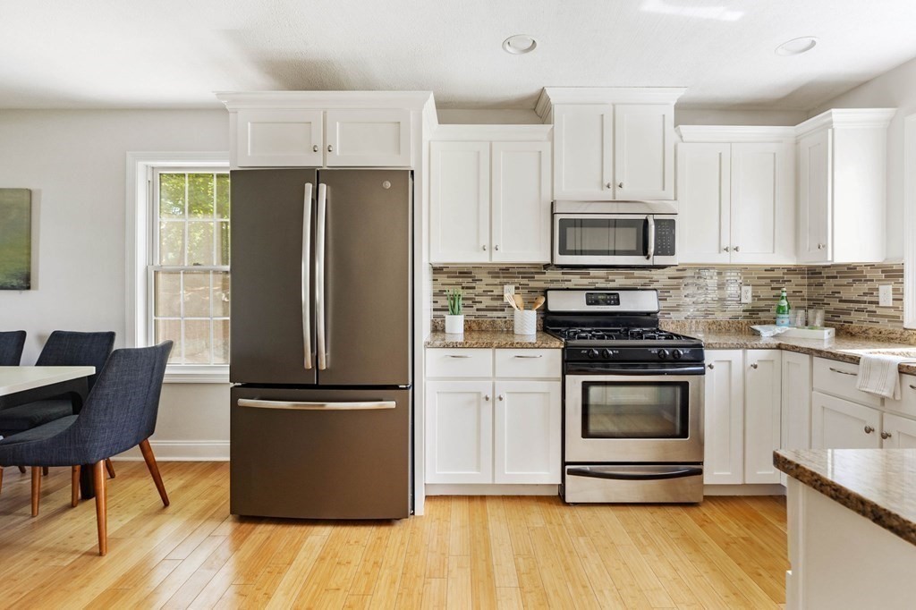 40 Brattle Street, Unit 7 Arlington, MA 02476 - Photo 8 of 25 a kitchen with granite countertop a refrigerator stove and microwave