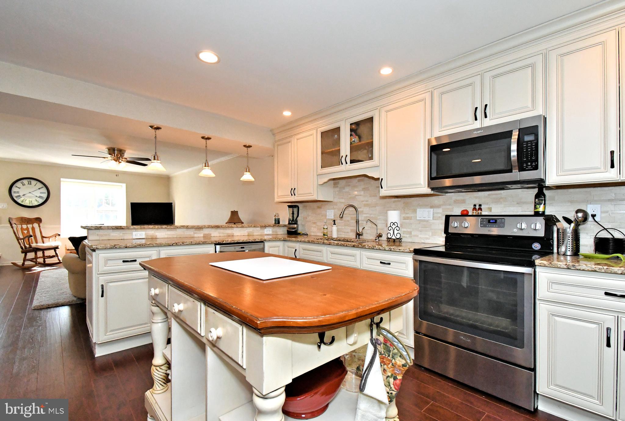 1903 Red Maple Grove Ambler, PA 19002 - Photo 13 of 32 a kitchen with stainless steel appliances stove microwave and cabinets