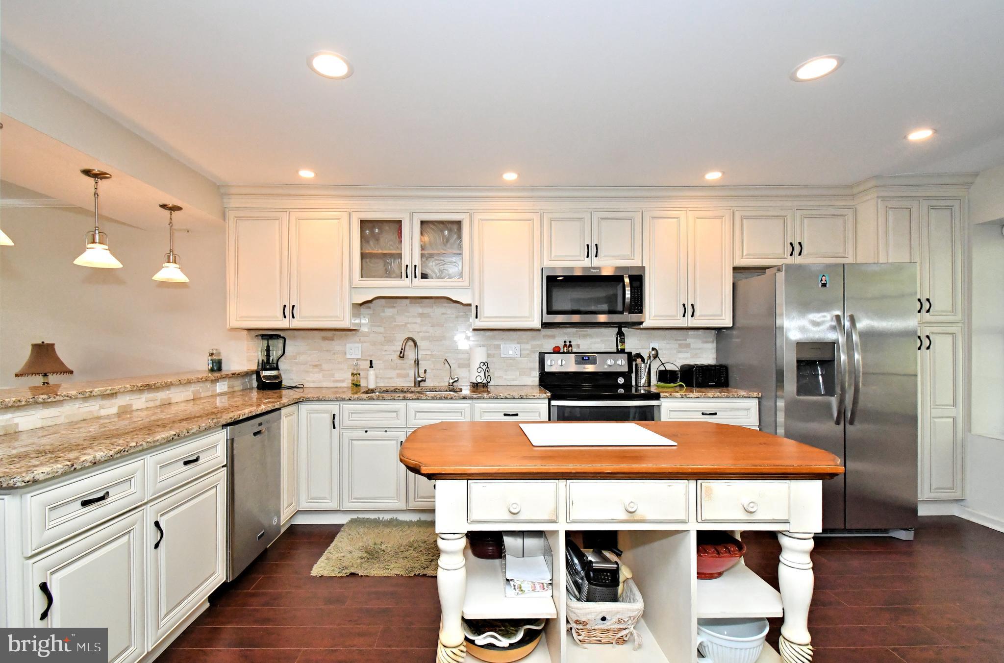 1903 Red Maple Grove Ambler, PA 19002 - Photo 14 of 32 a kitchen with stainless steel appliances granite countertop a sink stove refrigerator and center island