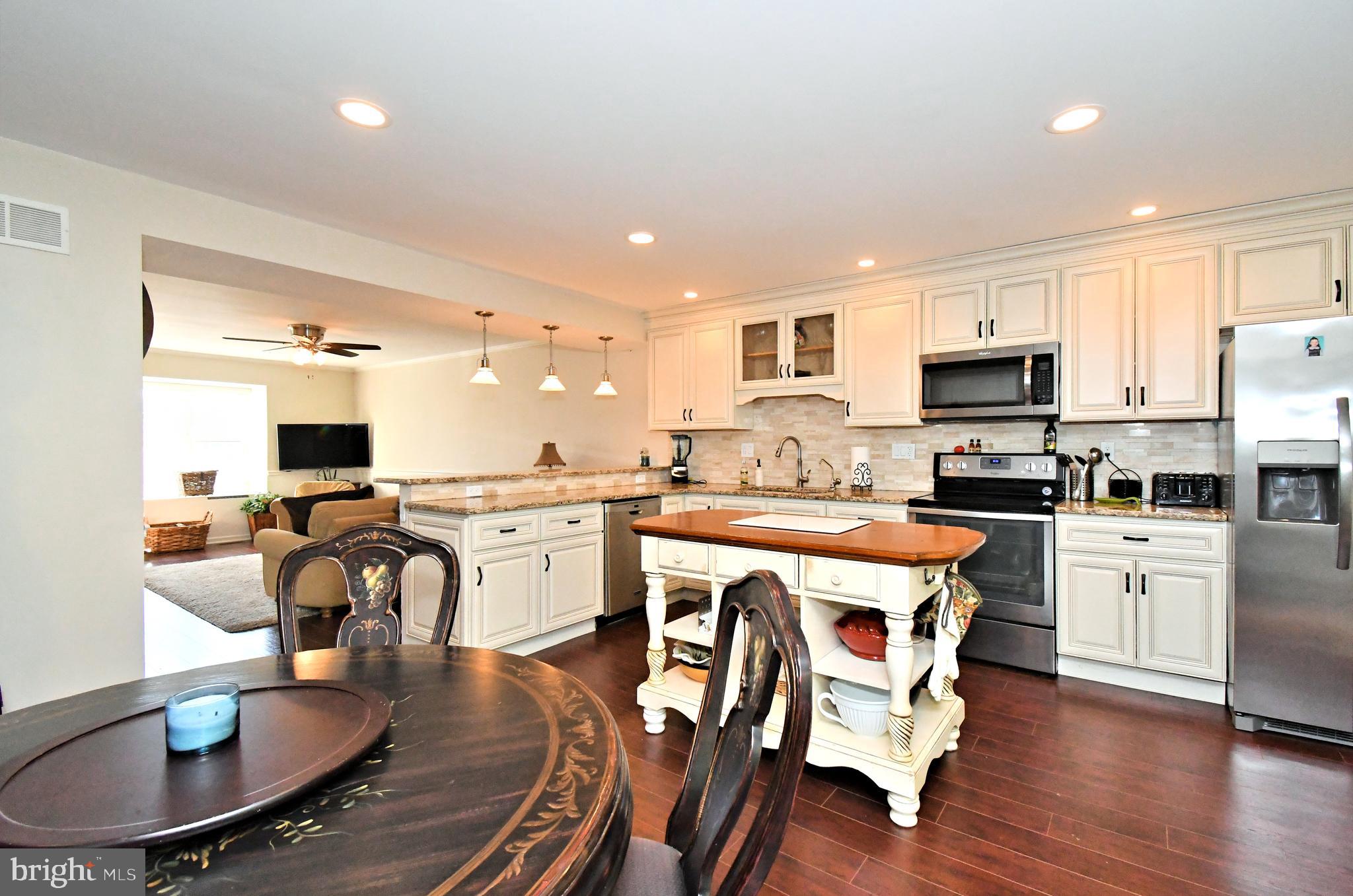 1903 Red Maple Grove Ambler, PA 19002 - Photo 18 of 32 a kitchen with white cabinets stove and kitchen island