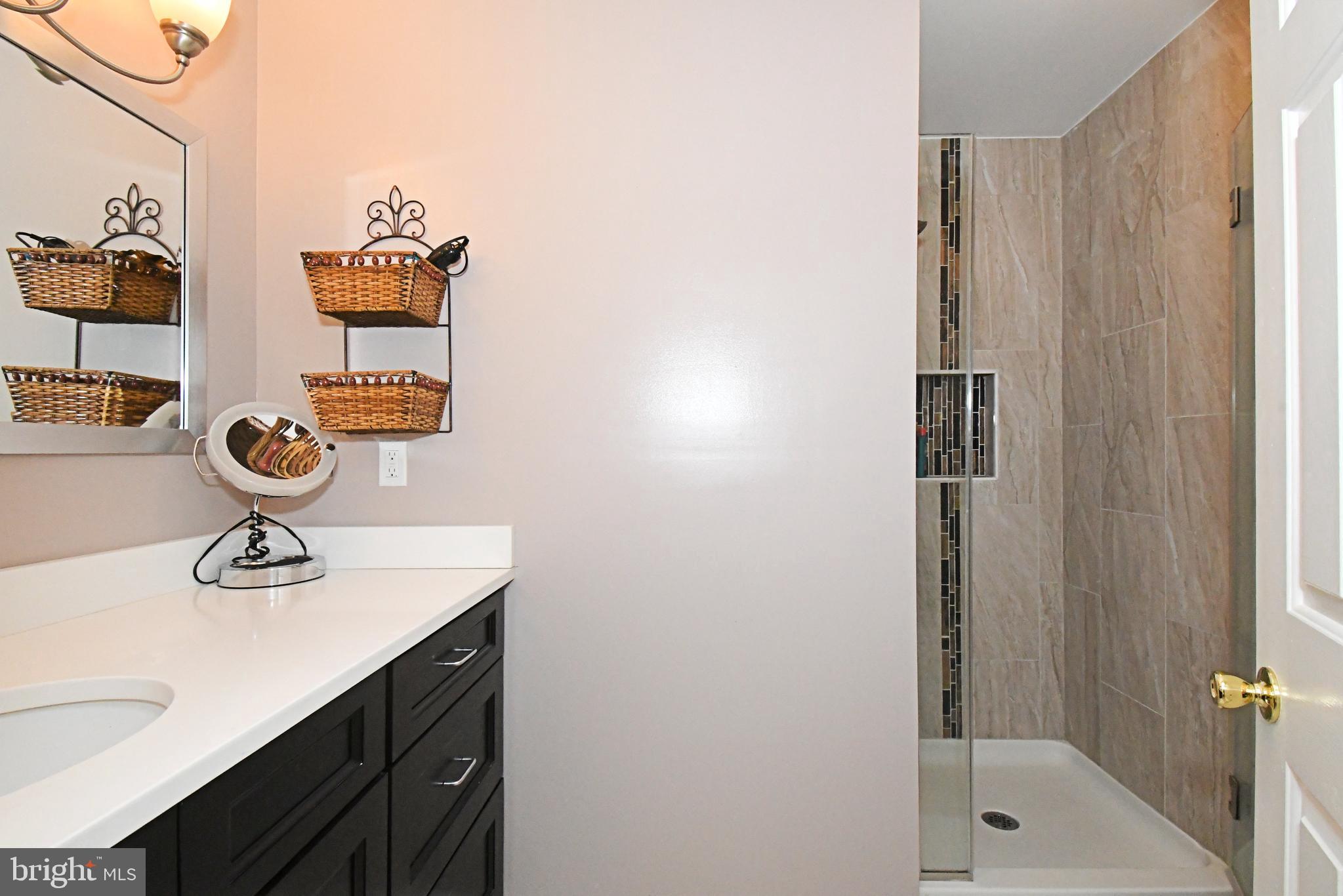 1903 Red Maple Grove Ambler, PA 19002 - Photo 29 of 32 a bathroom with a sink a mirror and shower