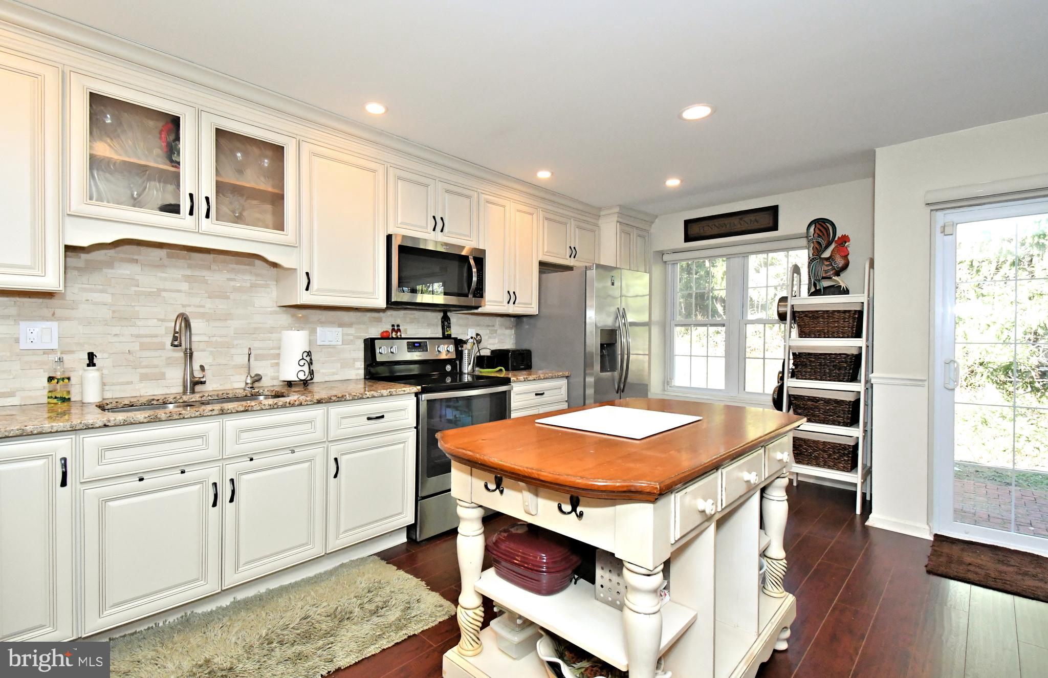 1903 Red Maple Grove Ambler, PA 19002 - Photo 10 of 32 a kitchen with stainless steel appliances granite countertop a sink stove and refrigerator