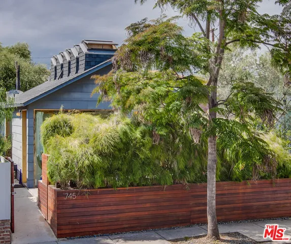 a wooden bench sitting in front of a building