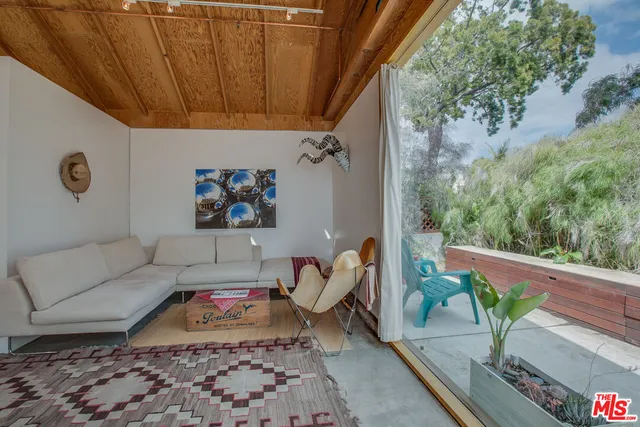a view of a livingroom with wooden chairs