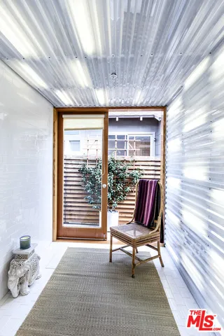 a living room with furniture and a floor to ceiling window