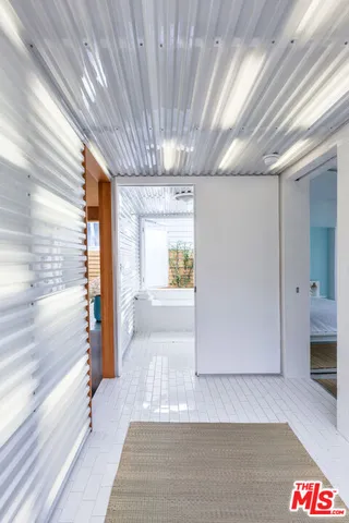 a kitchen with granite countertop lots of clutter and stainless steel appliances