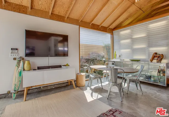 a view of a dining table and chairs in the balcony